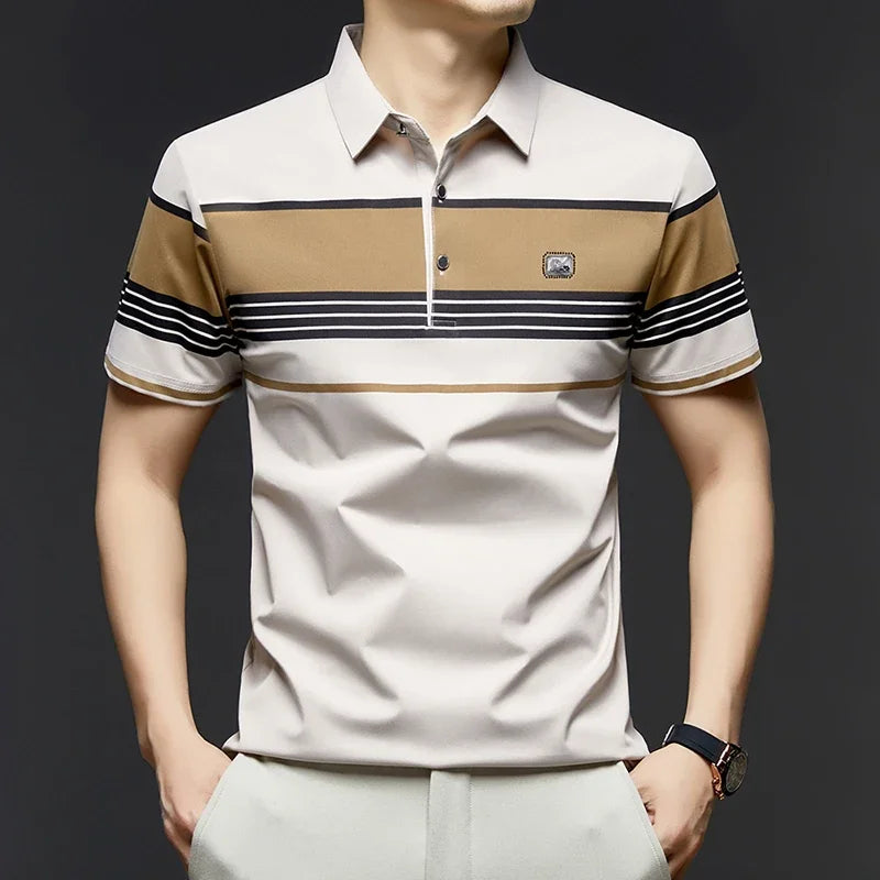 Man wearing a beige and brown striped polo shirt with a dark background
