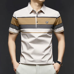 Man wearing a beige and brown striped polo shirt with a dark background