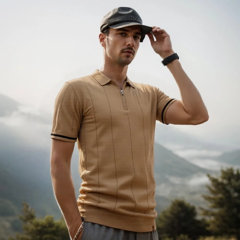 Man wearing a beige polo shirt and cap with mountains in the background