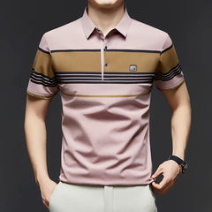 Man wearing a pink polo shirt with brown and black striped accents on a dark background
