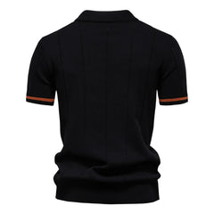 Black polo shirt with orange accents on a white background