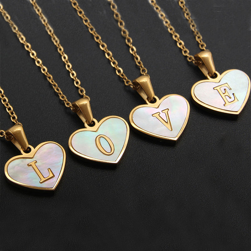 A collection of gold-plated stainless steel pendant necklaces with heart-shaped pendants in various colors.