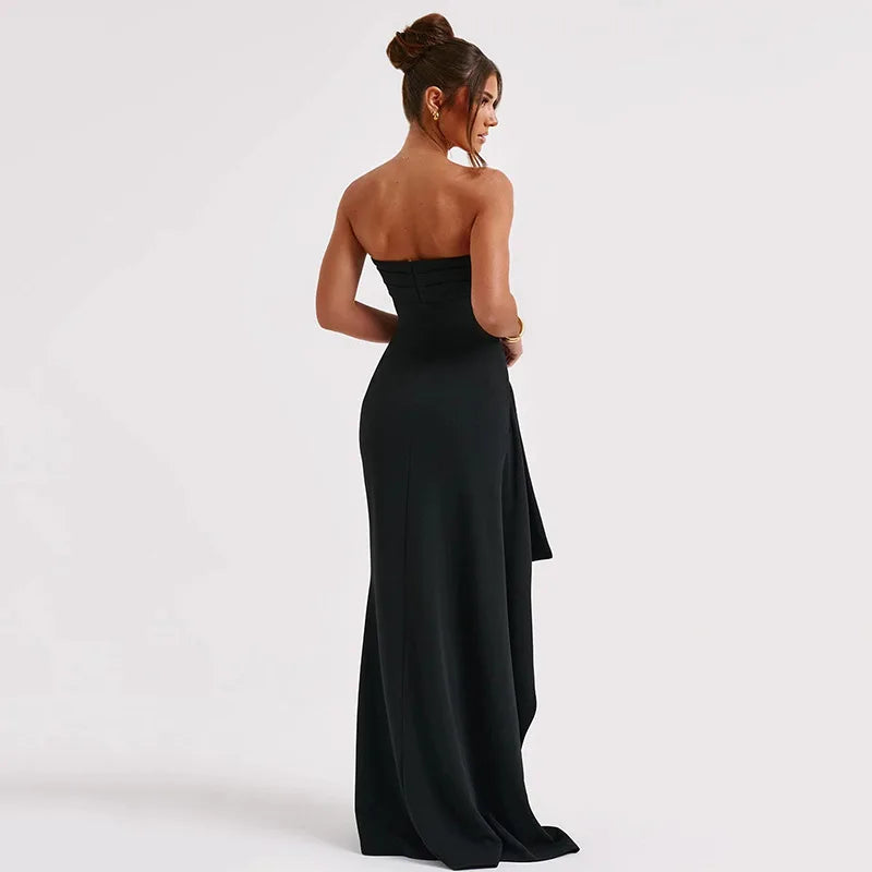 Woman wearing a black strapless gown on a white background