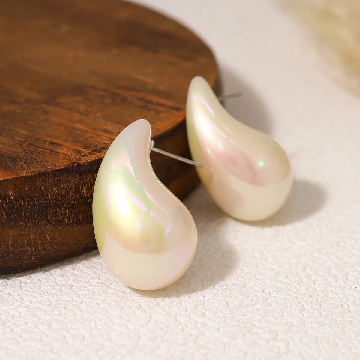 Pearl earrings on a wooden surface