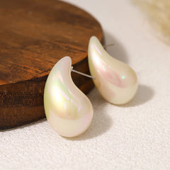 Pearl earrings on a wooden surface